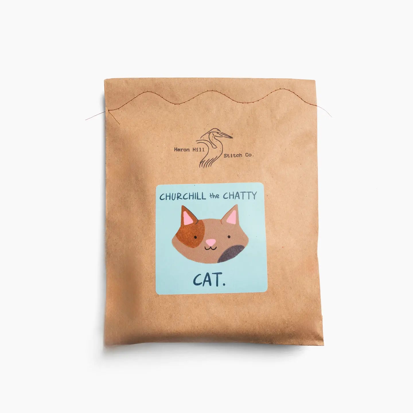 a brown bag package with a felt cat kit