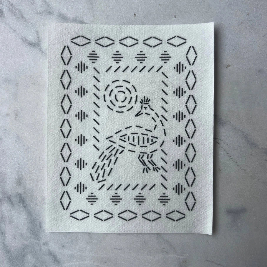 White cloth with black geometric pattern on a gray marble surface