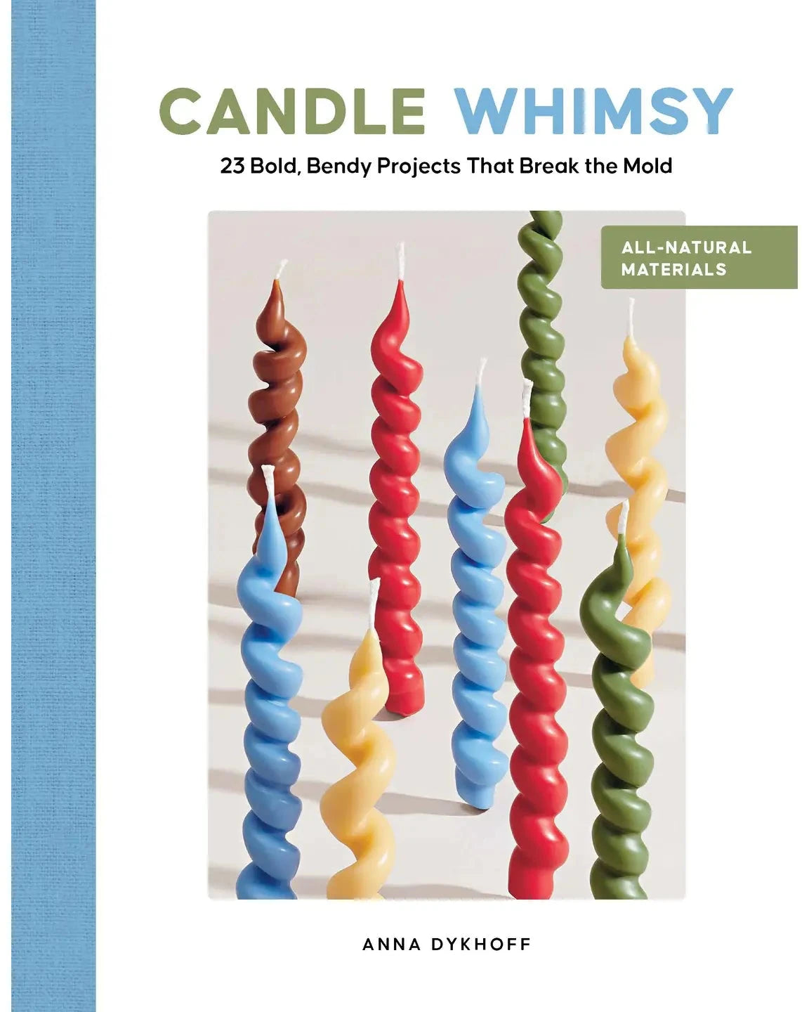 Book cover for 'Candle Whimsy' by Anna Dykhoff, featuring a light blue textured spine band, green and blue title text, and a central photo of colorful spiral taper candles in brown, blue, red, yellow, and green.