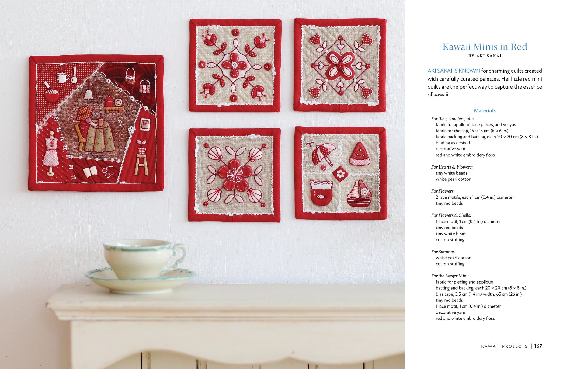Set of red and white quilted squares on a wall above a table with a teacup.