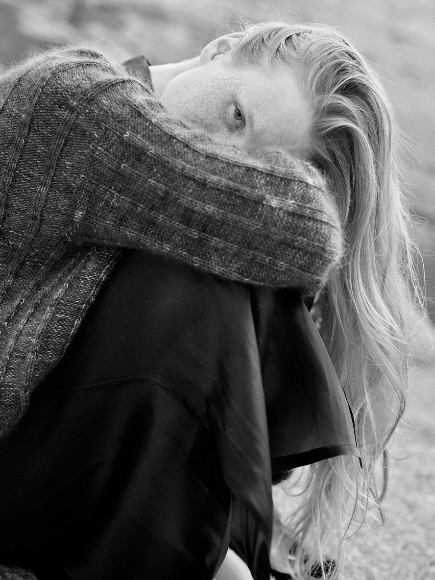 Person with long hair and a scarf in black and white
