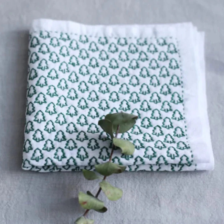 a sashiko cloth with green tree on a white background