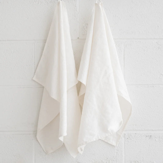 2natural cotton tea towels hanging by a loop