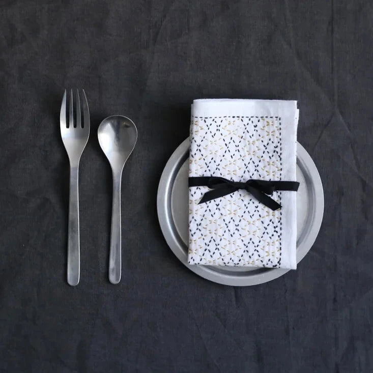 a sashiko stitched napkin on a plate with silverware